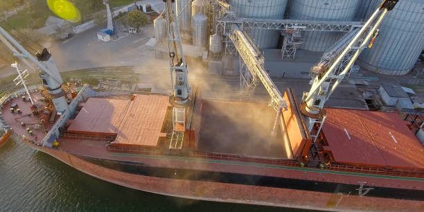 Aerial view of big grain elevators on the sea.
